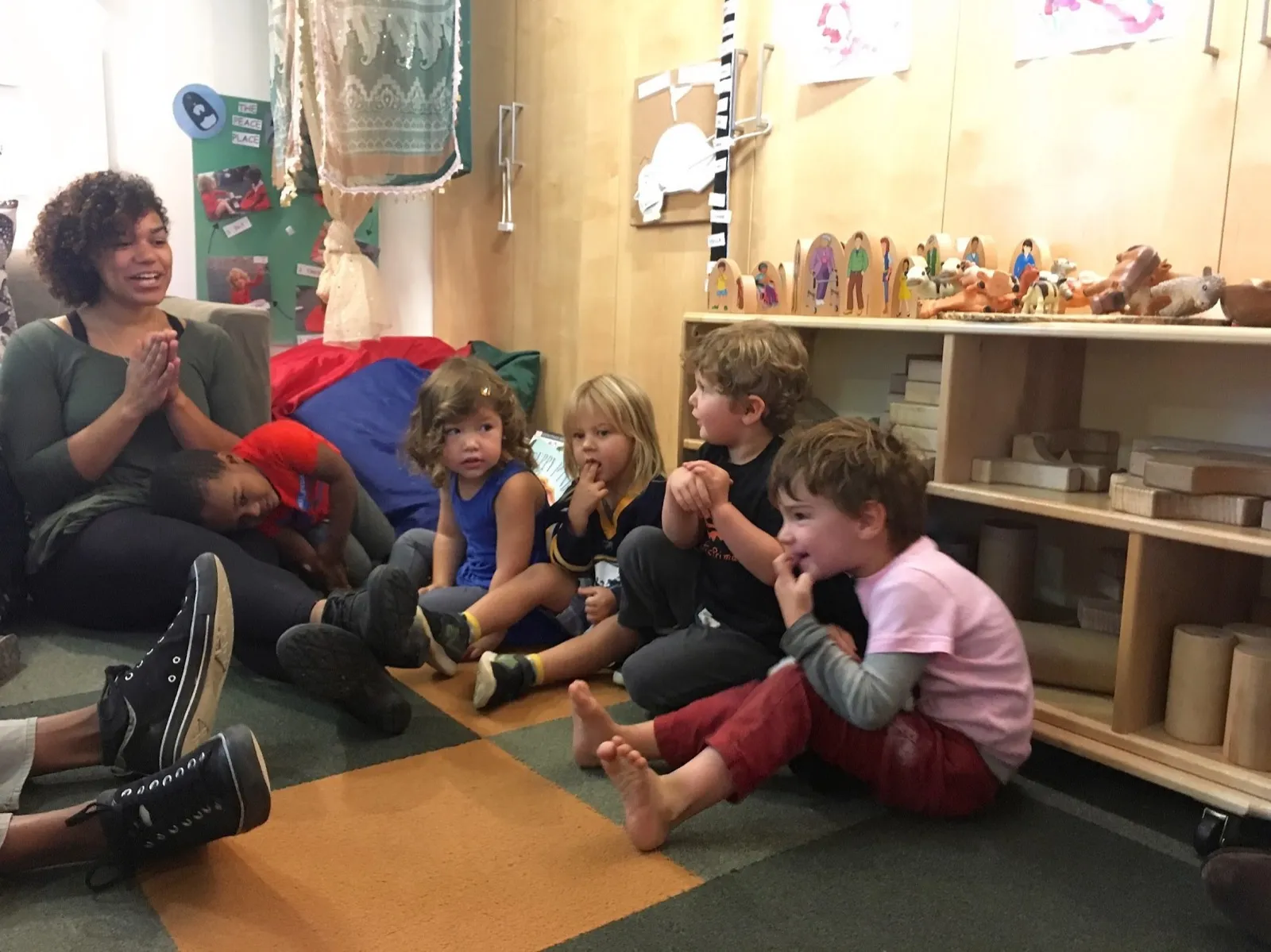A Pacific Primary teacher working with children