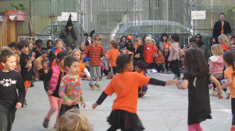 A teacher and children laughing during circle time