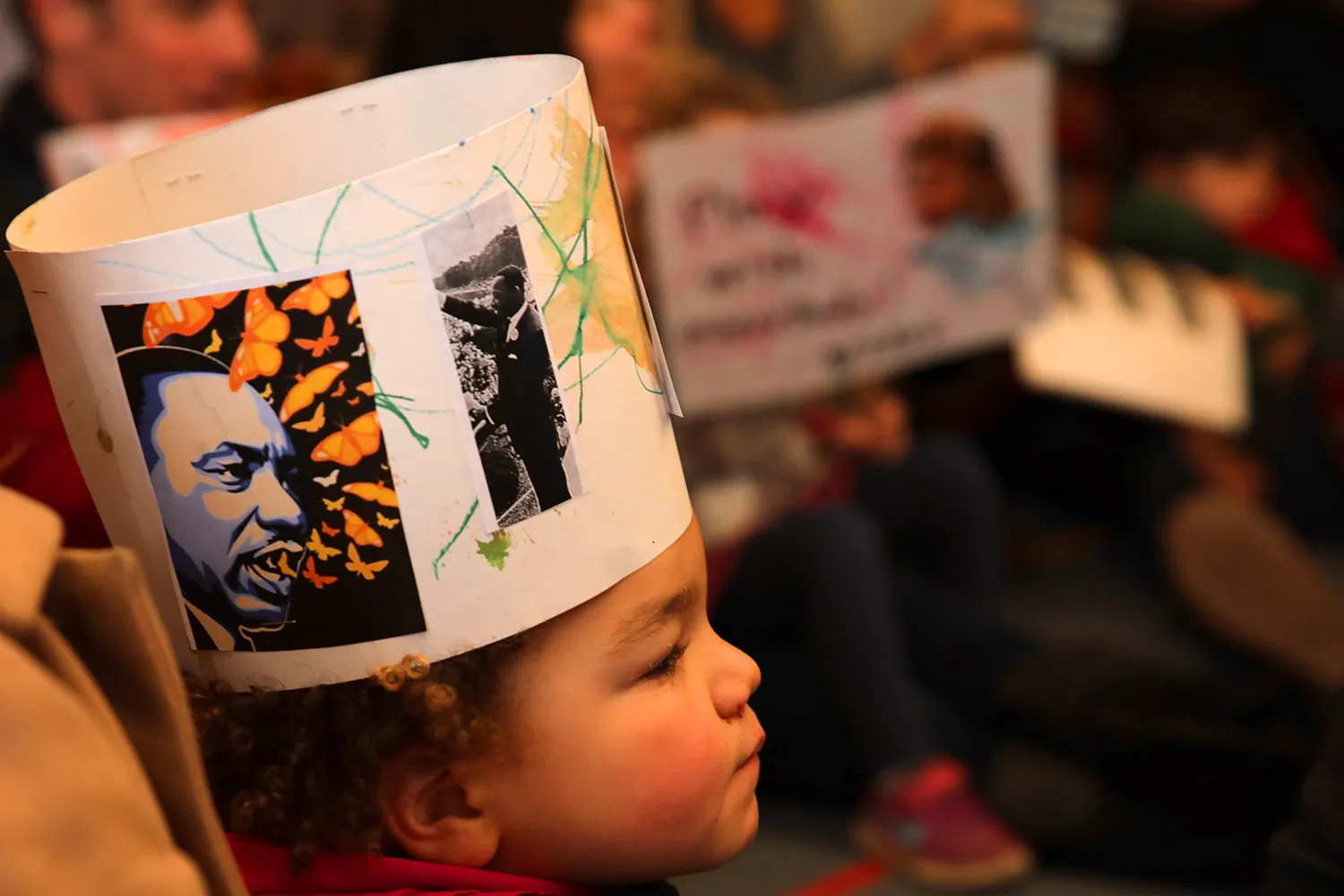 A child wearing a hand-made Peace Parade hat